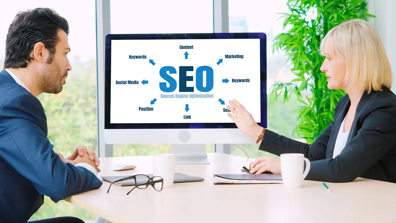 Two business professionals discussing a Search Engine Optimization (SEO) strategy in a meeting